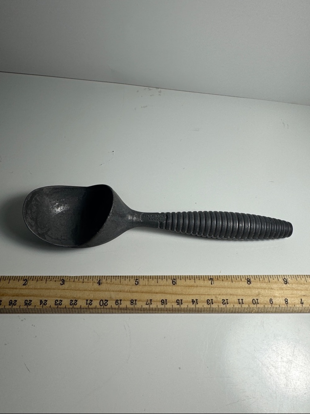 vintage aluminum ice cream scoop produced by Progressus during mid-20th century